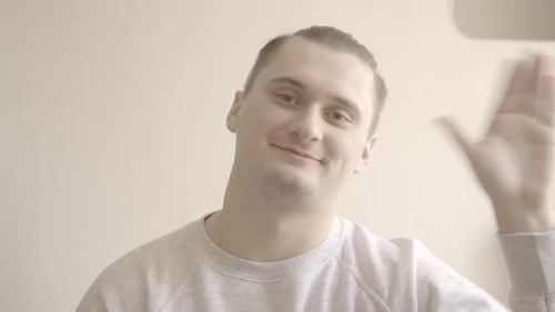 Friendly Man Waving Hello Indoors