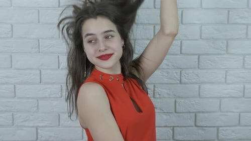 Beautiful girl straightens her hair.