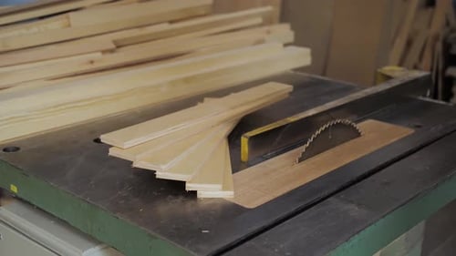 Table Saw in Factory Workshop With Lumber