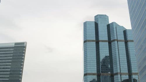 Close-Up Glass Skyscrapers at Daylight, Sky Reflection at Facades Corporate Buildings