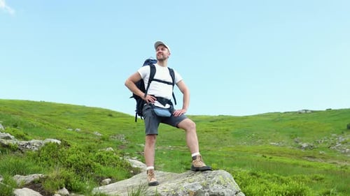 Man Hiking in the Mountains on a Sunny Day