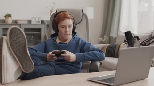 Boy Relaxing by Playing Computer Game