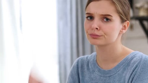 Thumbs Down By Woman Disliking and Rejecting Close Up