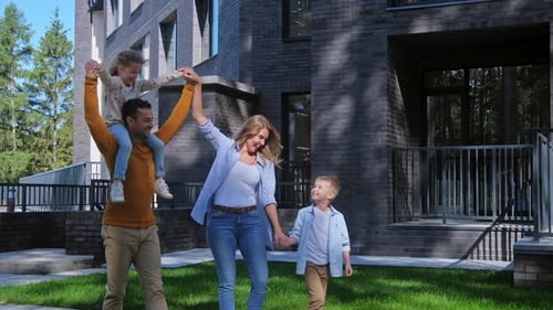 Cheerful Family Enjoying Walk Together on Lawn
