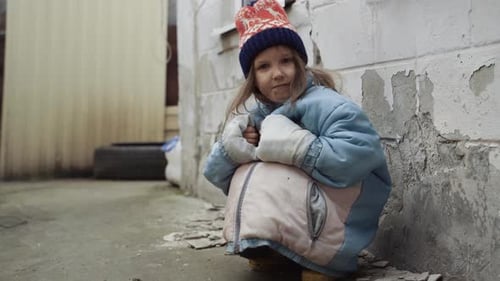 Lonely Child Crouching in an Urban Alleyway