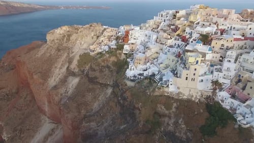 Flying over beautiful and famous Oia on Santorini Island in Greece during sunrise