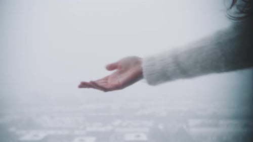 Hand Reaching in Snowy Overcast Weather