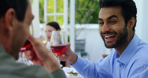 Friends interacting with each other while having wine