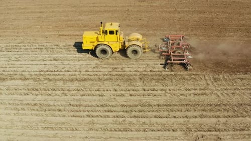 Tractor with Disc Harrows on the Farmland