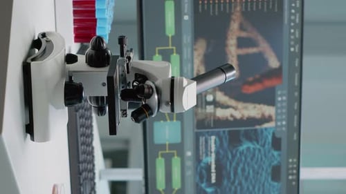 Microscope in Laboratory with DNA on Screen