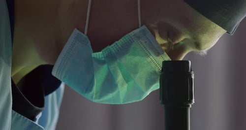 Close-up Shot. The Lab Worker Is Looking Through a Microscope. Experiments in the Laboratory. Search