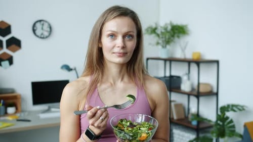 Woman With Salad Bowl and Fork Indoors