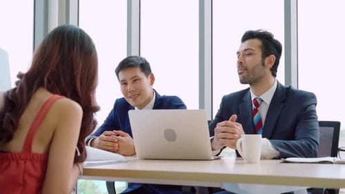 Woman Interviewing With Two Men in Office
