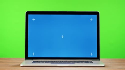 Laptop with Blue Chroma Key on Green Background Closeup