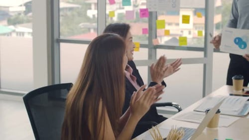 Team Celebrates Success in Modern Office