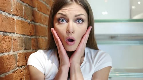 Surprised Young Woman Gasping Indoors