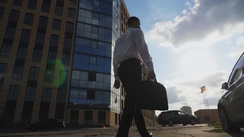 Man Walks to Car in an Urban Setting