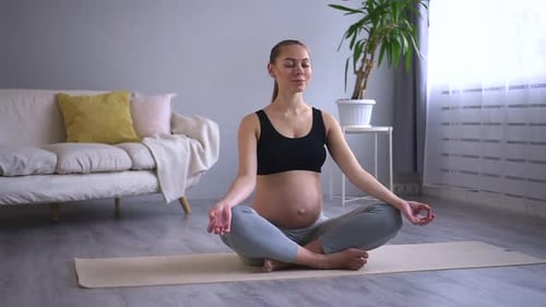 Healthcare and Prenatal Yoga Woman Meditates in Living Room Spbd