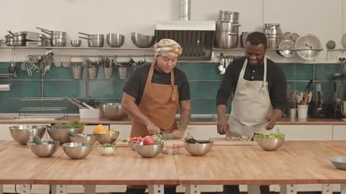 Chefs Preparing Vegetables Together in Commercial Kitchen