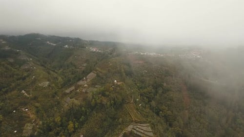 Farmland in the Mountains in Fog and Clouds