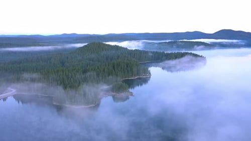 Fly over the morning fog over the mountain lake, Rodopi mountain Bulgaria