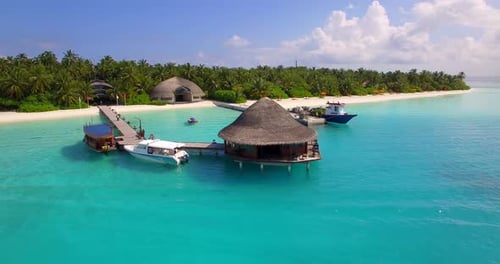 Aerial drone view of a scenic tropical island resort hotel in the Maldives