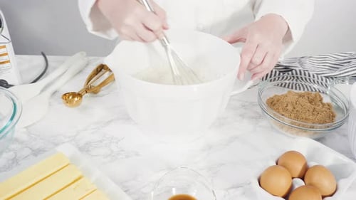 Step by step. Mixing ingredients in a glass bowl to make chocolate chip cookies.