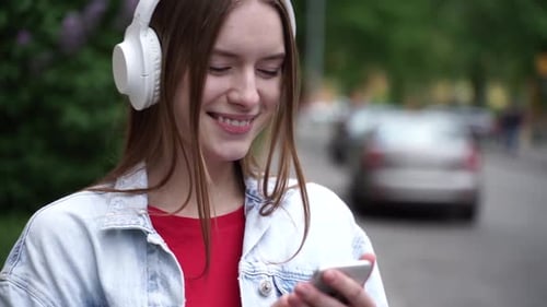 Young Woman Using Phone in Urban Park