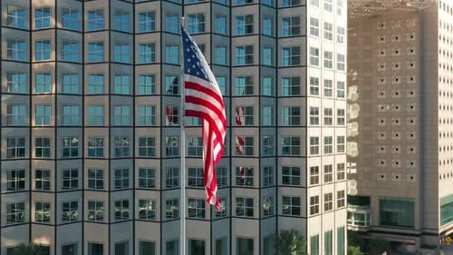 American Flag Waving in City Downtown Aerial View