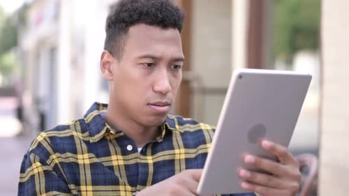Man with Tablet Having a Negative Reaction