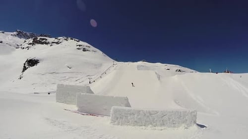 A young man snow boarding.