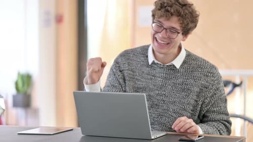 Man Works at Laptop Then Celebrates Achievement