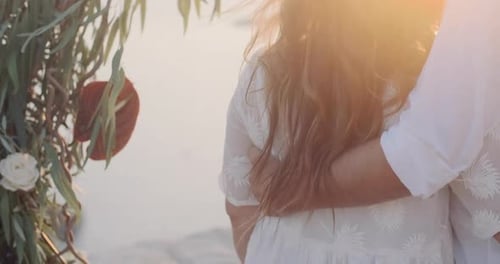 Romantic Couple Embracing at the Beach During Sunset