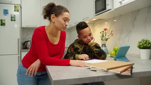 Stressed Woman Scolding Child for Poor Schooling at Home
