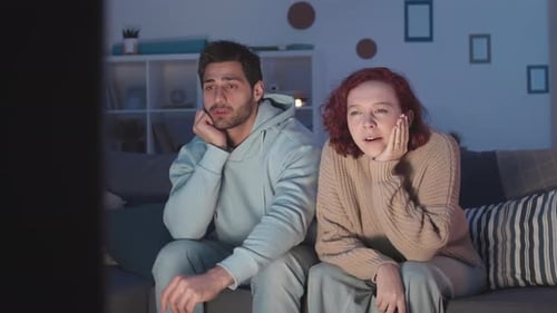 Sleepy Couple Turning off TV