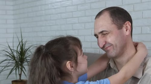 Child Hugging Adult Indoors with Love