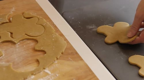 Gingerbread Men Cookies Being Cut From Dough