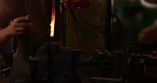 Blacksmith working at workshop