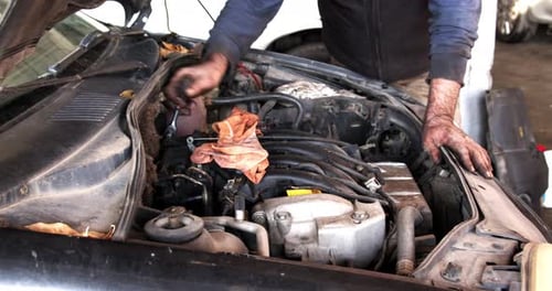 Mechanic Works With Socket Wrench In Car Engine