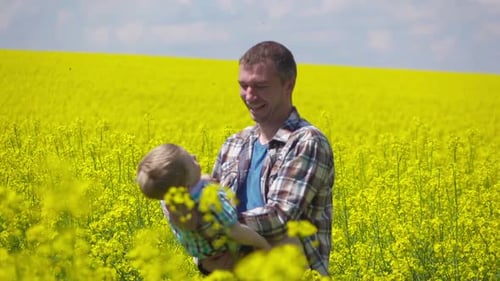 Father and Son Embrace in Bright Flower Field