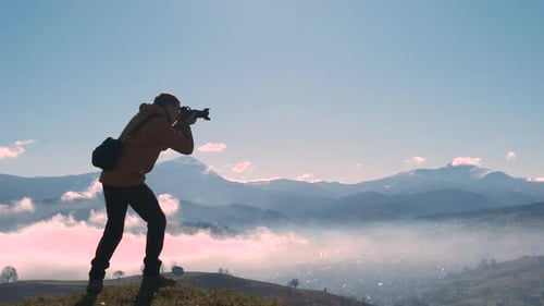 Photographer Taking Pictures of Beautiful Mountain View