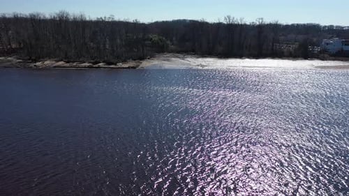 An aerial shot over a creek on a clear day. The drone camera truck right high up along the shores of