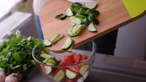 Person Making a Fresh Salad in Home Kitchen