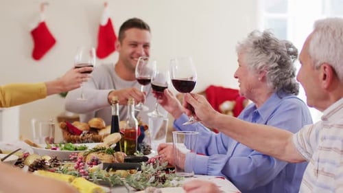 Multigenerational Family Toasts Wine at Christmas Dinner