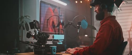 Profile view of a filmmaker working on the pc