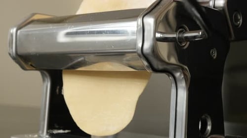 Metal pasta machine used at home close-up 4K 2160p 30fps UltraHD footage - Processing dough for Ital