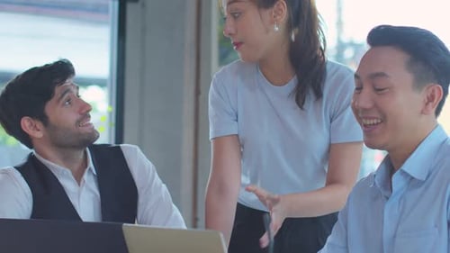 Collaborative Team Discussing Project in Modern Office