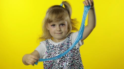 Kid Playing with Hand Made Toy Slime, Child Having Fun Making Turquoise Slime, Funny Pupil Girl