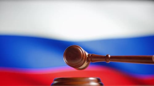 Gavel Strikes Block with Russian Flag Background