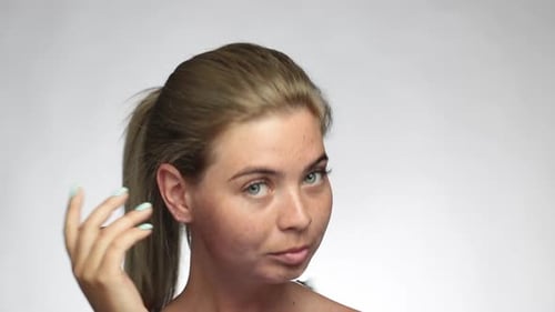 Blonde Woman Gently Touching Her Face